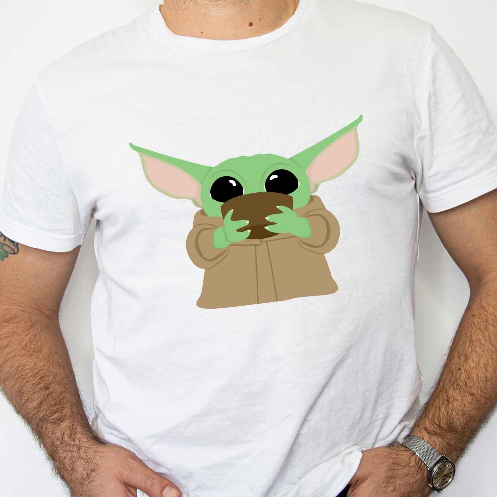 An image of a man wearing a white t-shirt with a design of Baby Yoda Sipping Soup on the front.
